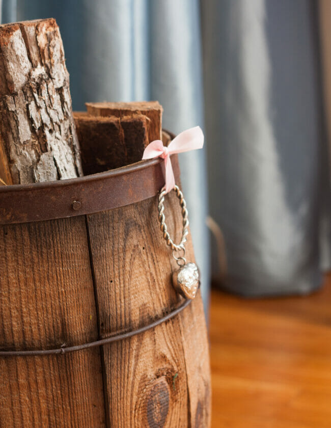 Silver heart hanging on old barrel