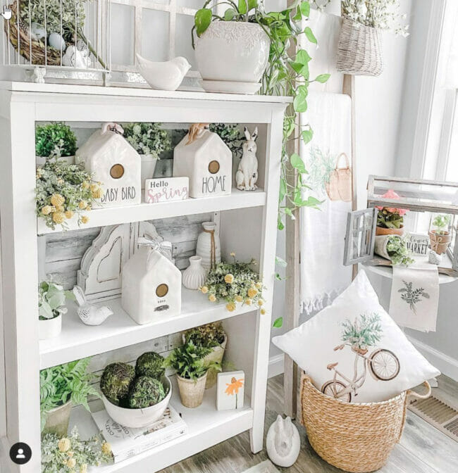 white book shelf with spring decor and bird houses and greenery