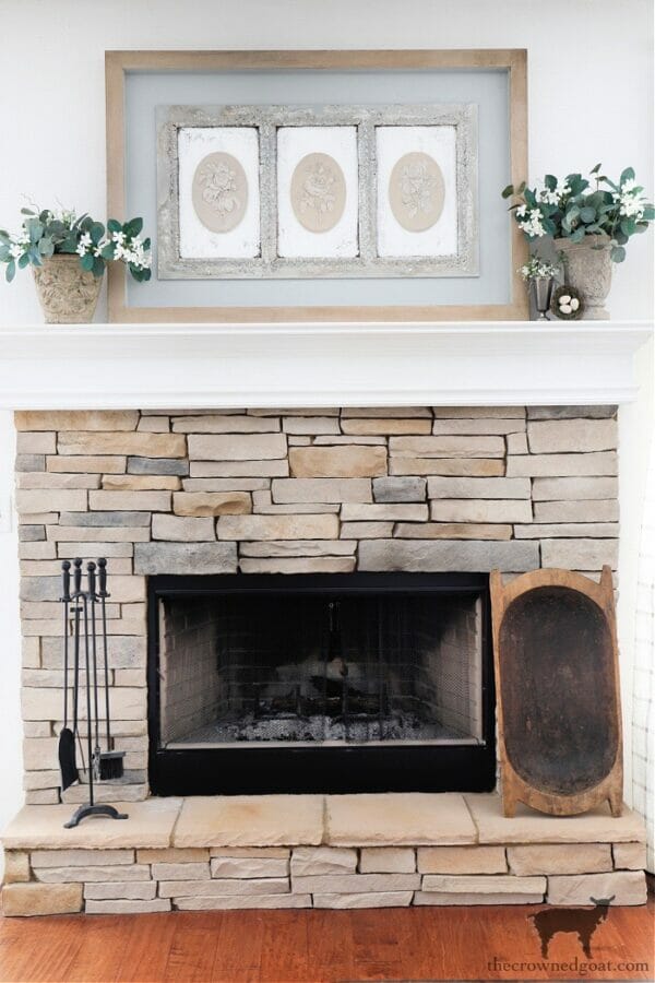 stone mantel with plants and plaster artwork