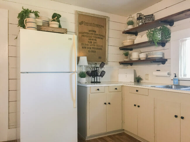 white fridge with open shelving and cabinets