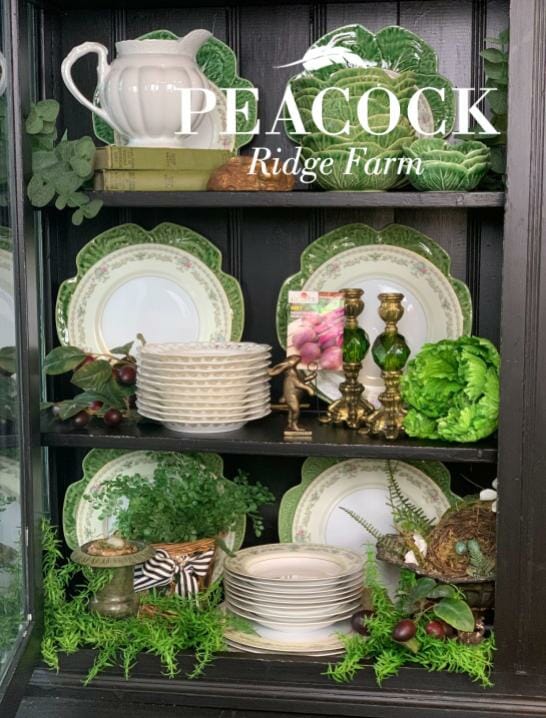 dark cabinet with green and white plates for spring decorating
