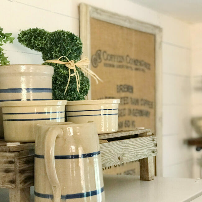 crocks and boxwood bunny on top of fridge.