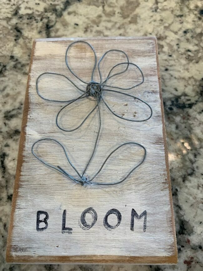 rustic wood piece with wire flower on front