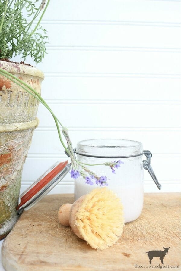 hand scrub in jar with brush and lavender 