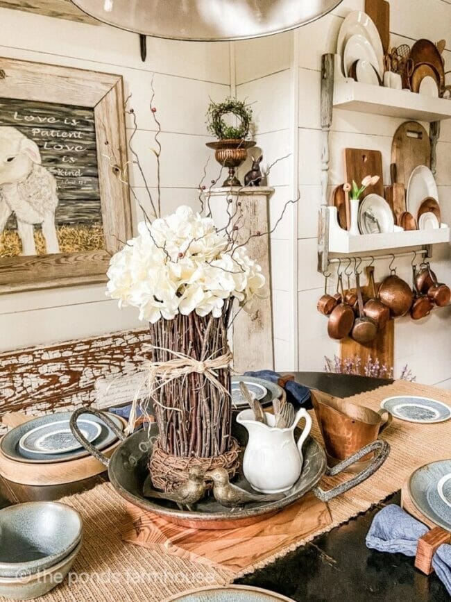 farmhouse table with twig vase centerpiece