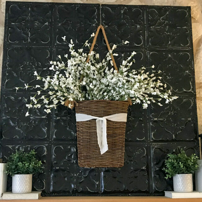 black ceiling tin with hanging basket of white flowers