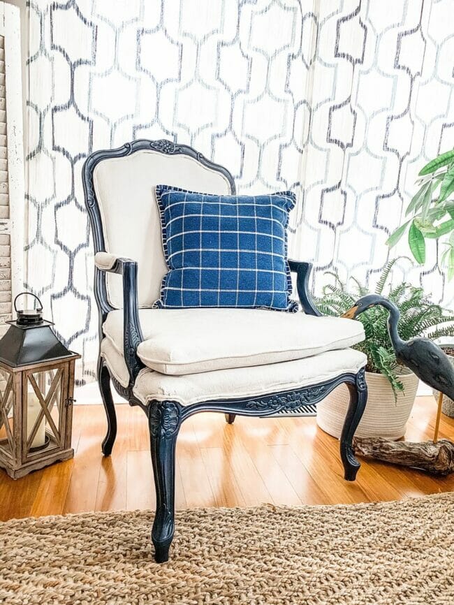 black and white chair with blue plaid pillow