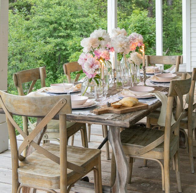 wood table with bottles and pink flowers