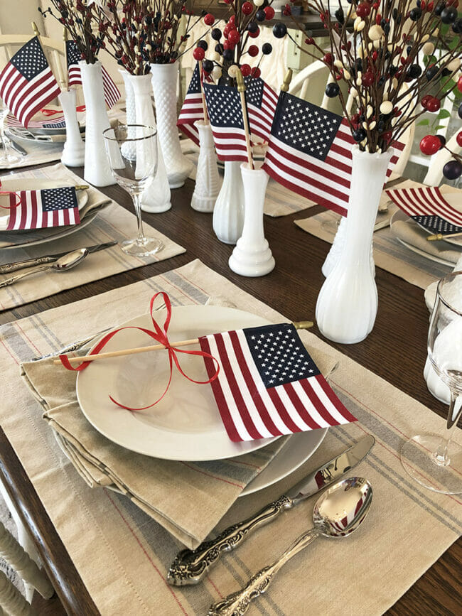 patriotic table with milk glass vases and flags