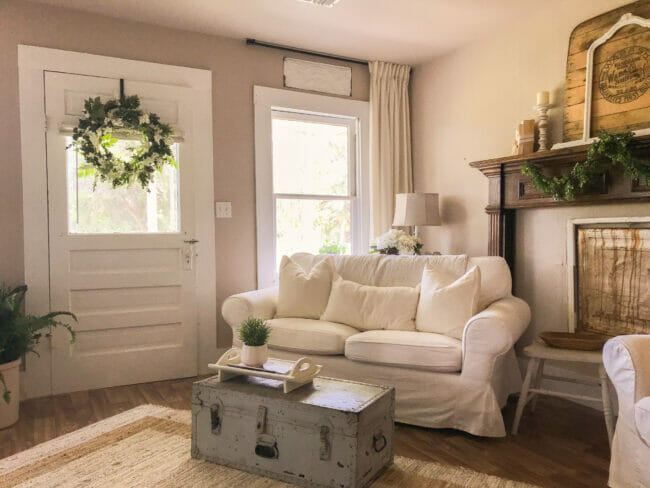 white sofa with gran truck coffee table, wreath on door