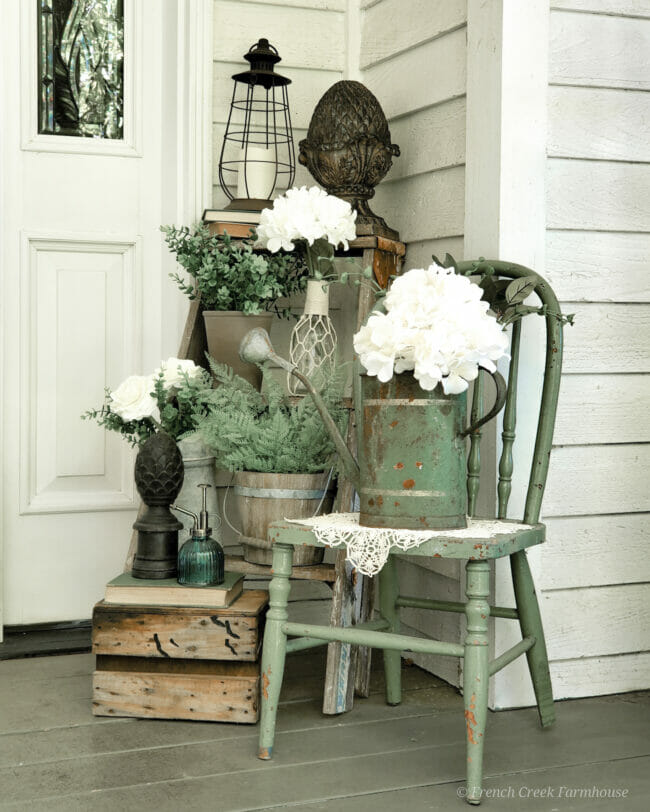 porch with vintage green items and white flowers