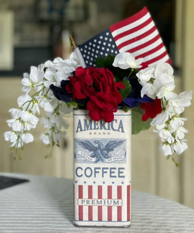 vintage coffee can saying America coffee with flowers and flag