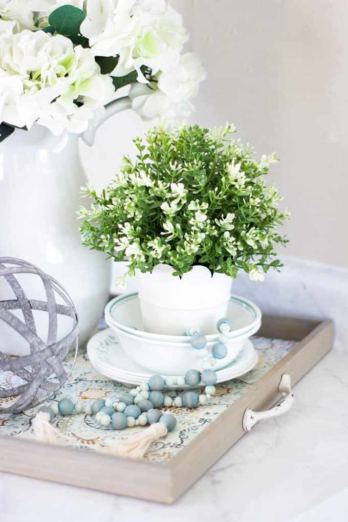 tray with beads, plant and white dishes