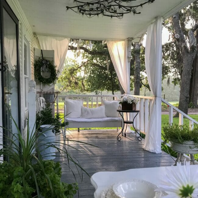 summer porch with white curtains and bed bench