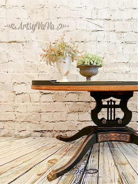 black and gold table with flowers on top