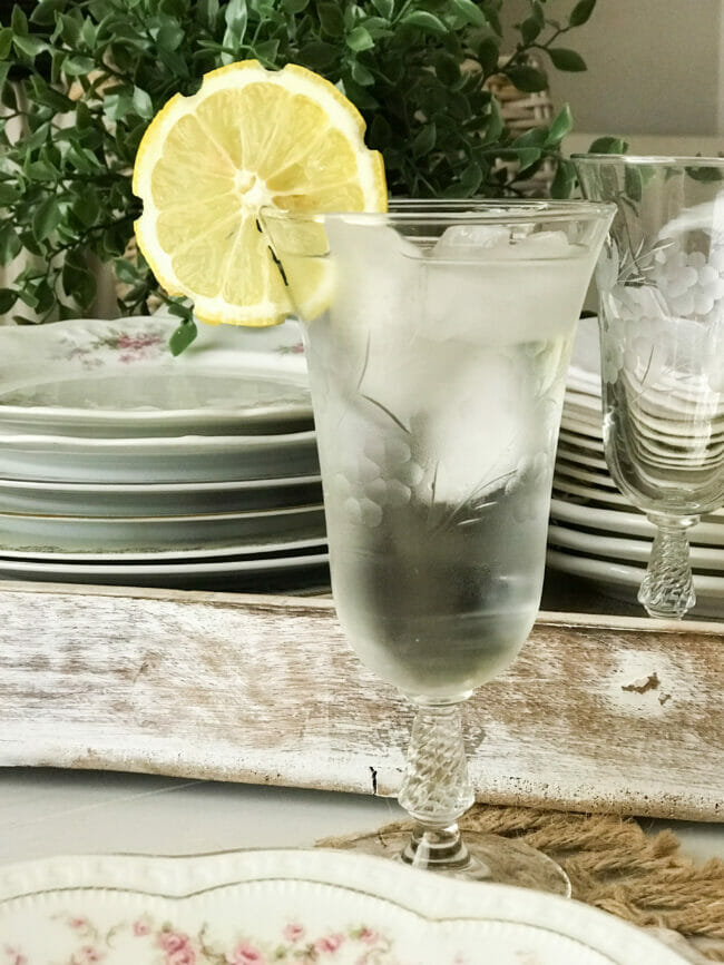 water glass with cut lemon slice on rim