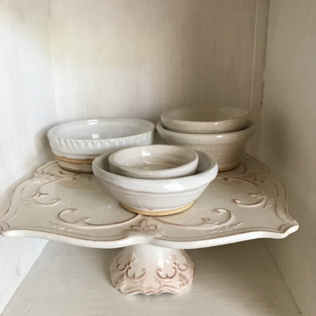 pottery bowls sitting on cake stand