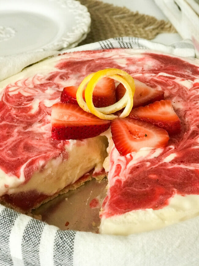 strawberry lemonade icebox pie with cut strawberries and lemon swirl on top