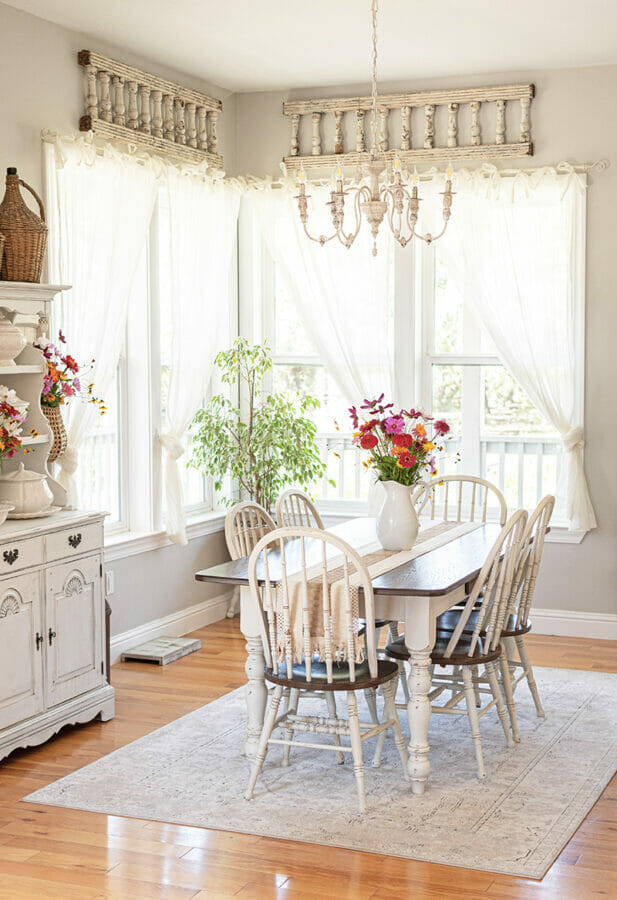 white dining room with fresh flowers on table