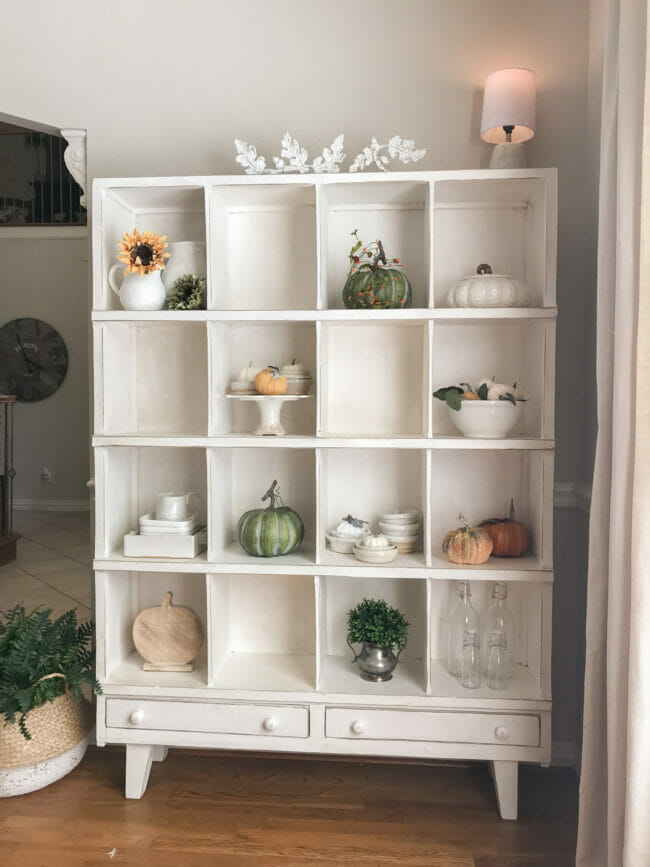 white cubby shelf with colorful fall decor