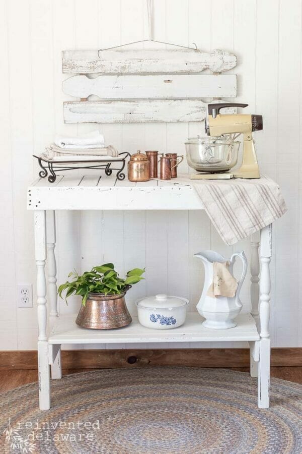 repurposed and handmade table with antiques on top