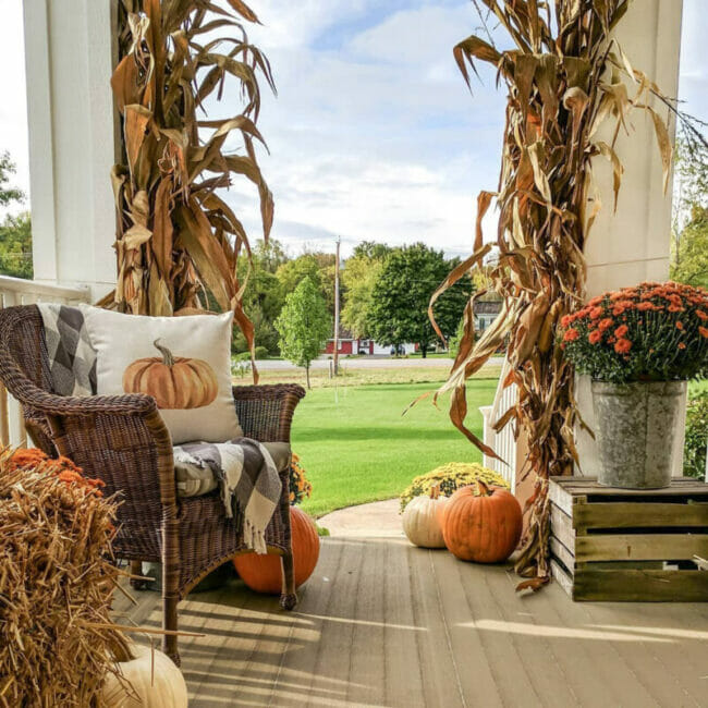 porch with cornstalks and pumpkins
