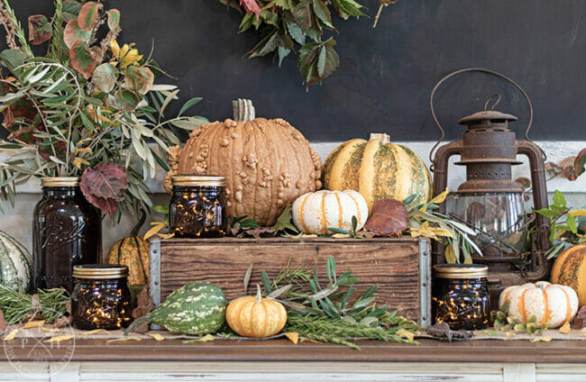 pumpkins in front of chalkboard sitting on a box