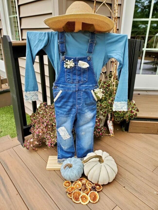 DIY scarecrow standing on porch