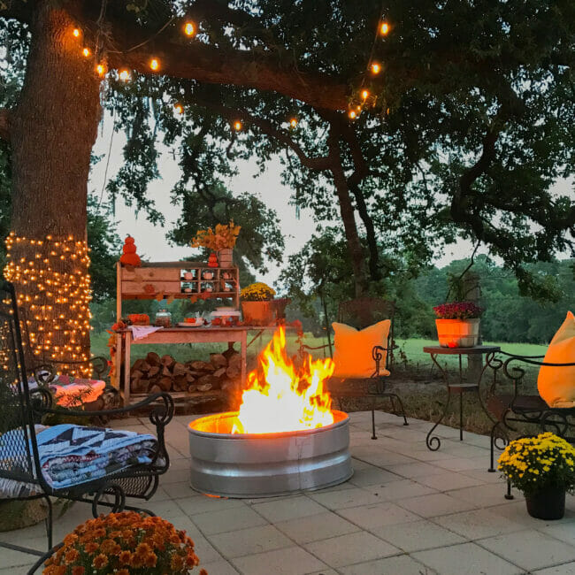 evening firepit area with seating and lights