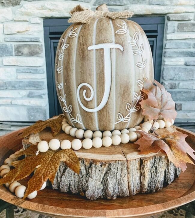 wooden pumpkin on a log slab with beads