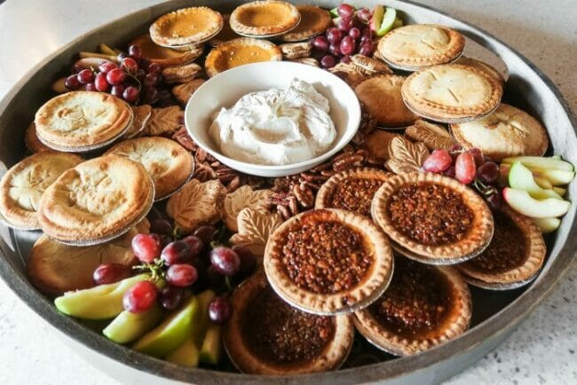 mini pie board with whip cream in bowl in the middle