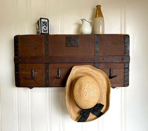 Trunk on wall with hat