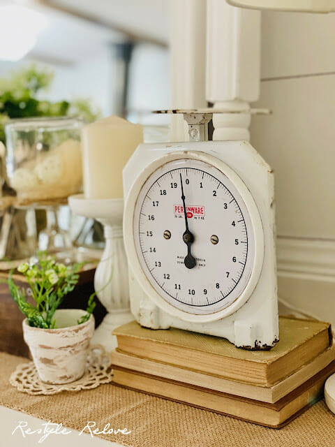 vintage scale sitting on books with small plant