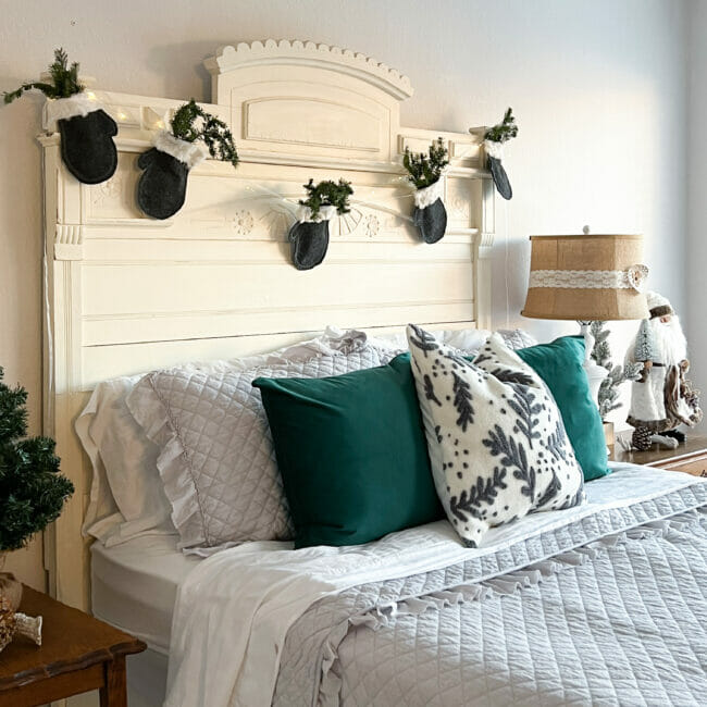 bed with mitten garland hanging on headboard