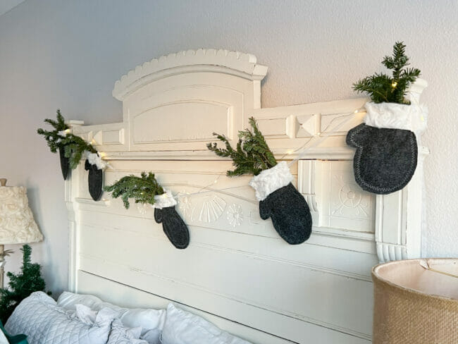 headboard with mitten garland hanging on it