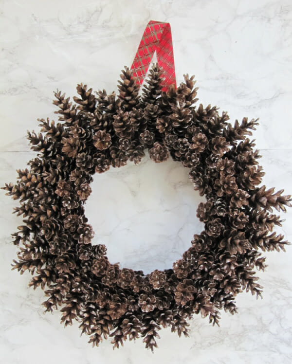 pinecone wreath with red ribbon