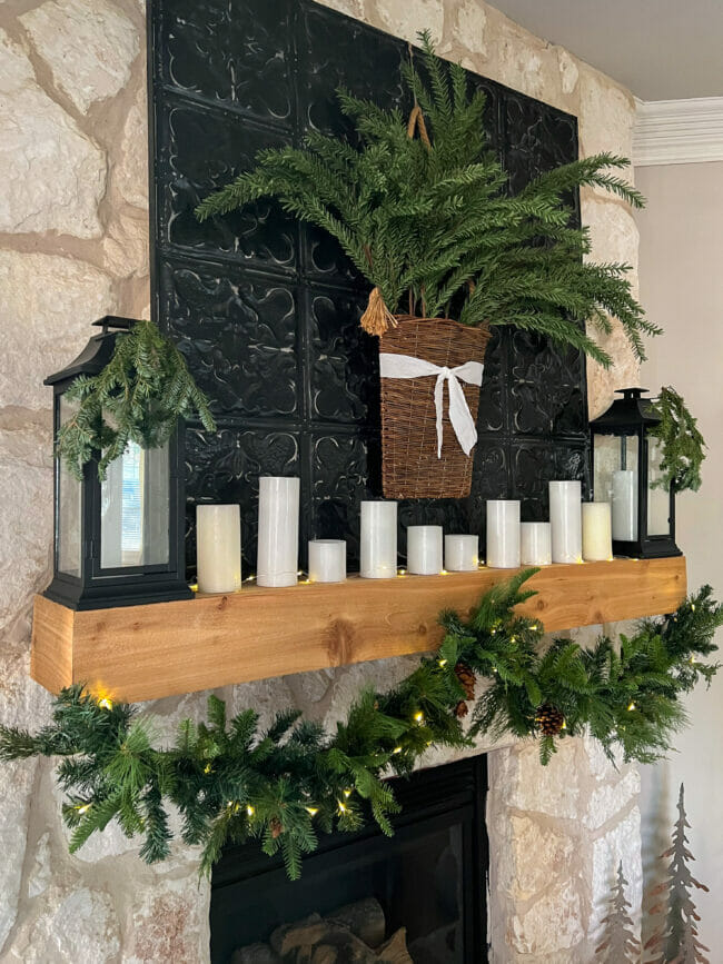 Christmas mantel with garland and white candles