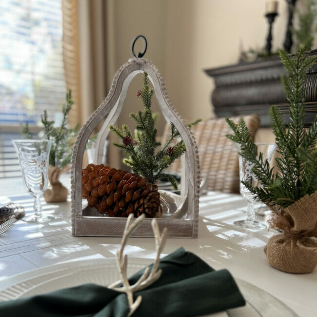 table centerpiece with pinecone, tree and antler
