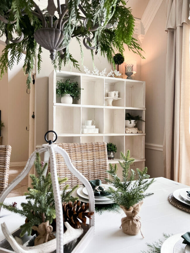 white cubby shelf with Christmas greens