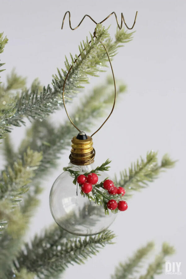 lightbulb ornament hanging on Christmas tree branch