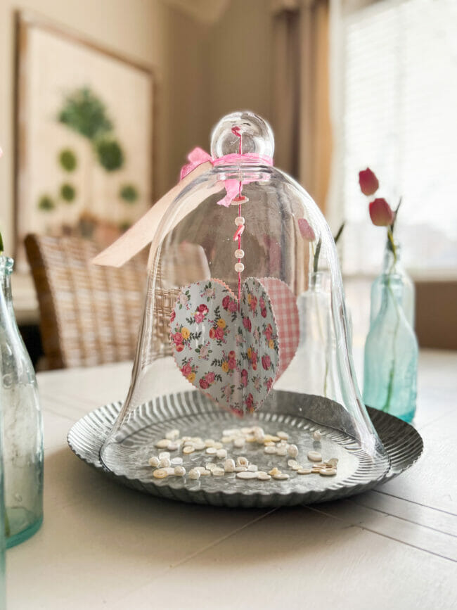 glass cloche with paper heart and buttons on galvanized charger