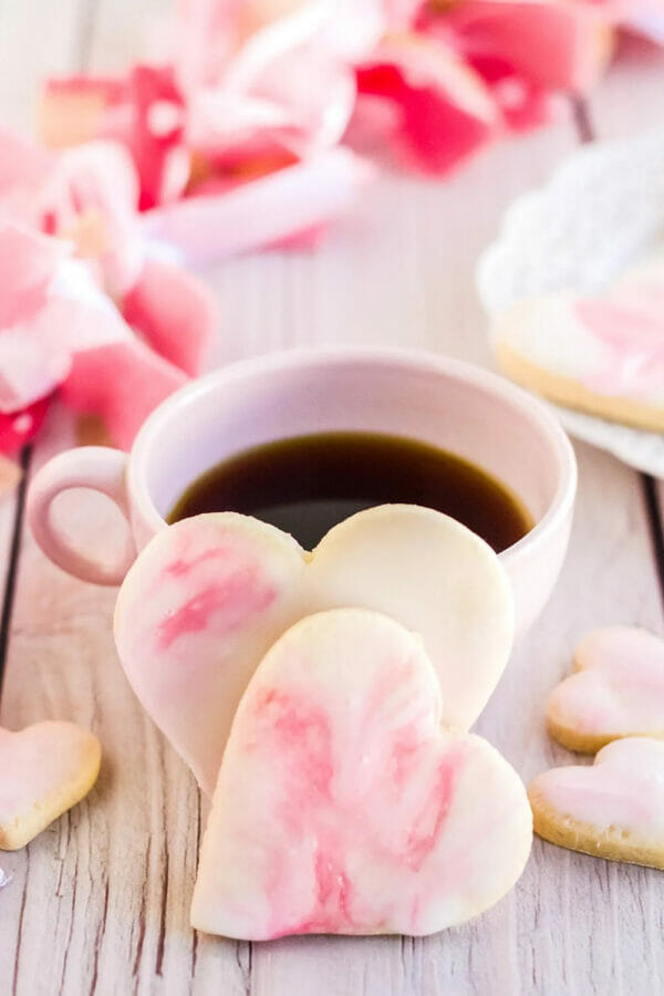 swirl heart cookies propped up beside coffee