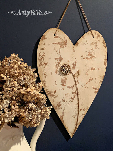 rustic heart hanging on wall with dried hydrangeas 