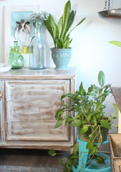 cabinet with plants and blue stool