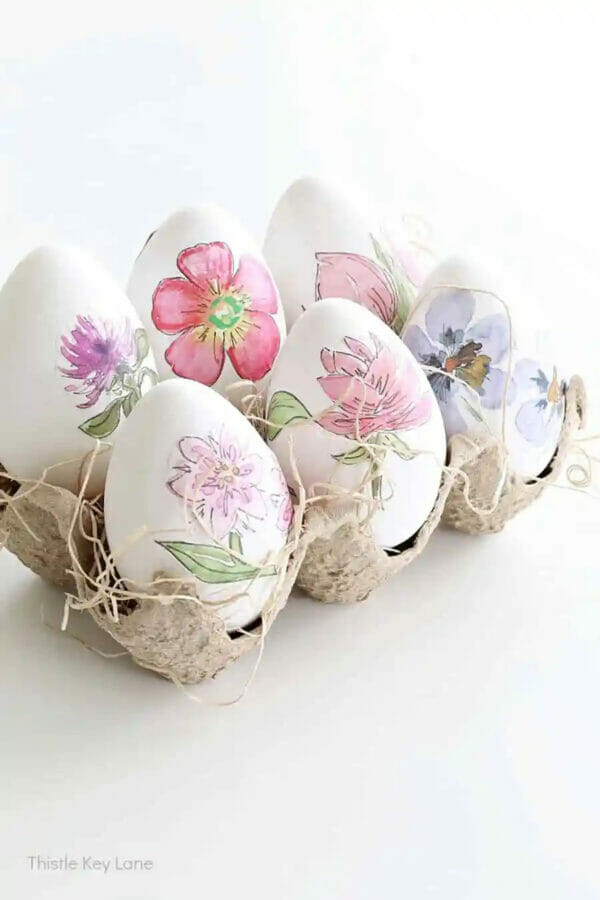 flowers decoupaged on eggs in carton