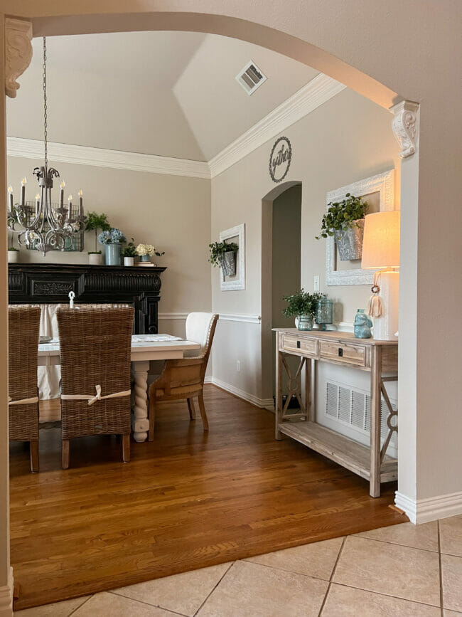 dining room with table and chairs and side table with blue accents and black mantel