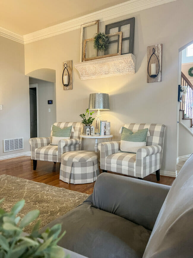 gray and white checked chairs with lamp and wall art