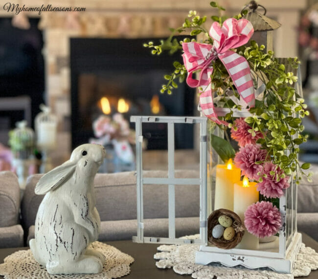 flowers on lantern with bunny on sofa table