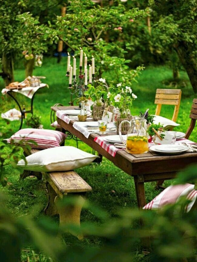 outdoor table with pillows, on a bench and wooden table