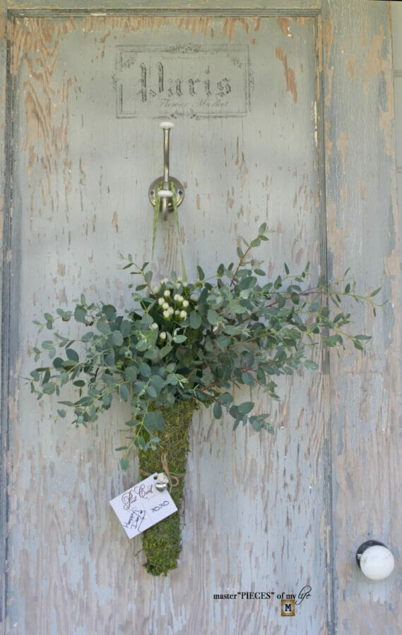 moss cone hanging on door with Eucalyptus